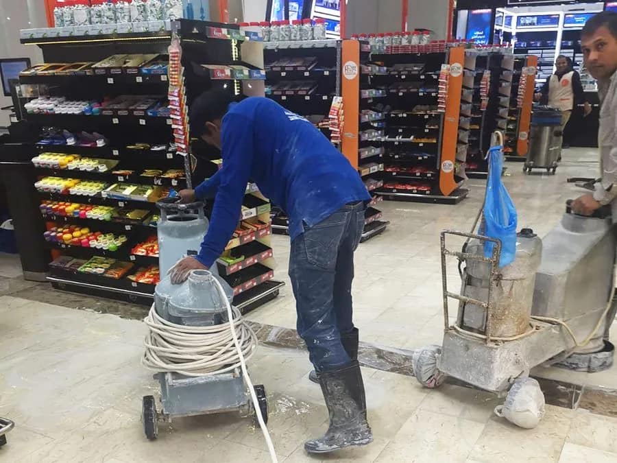 Commercial cleaning Service A men cleaning floor of a commercial building - wearing blue shirt
